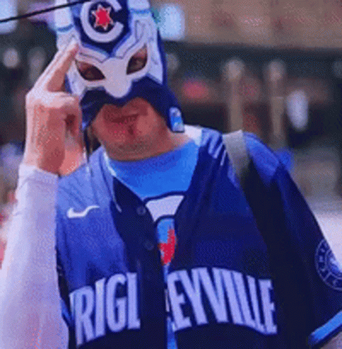 A Man Wearing A Blue Jersey That Says Rigleyville GIF