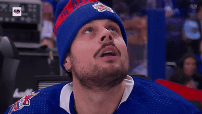 A Man Wearing A Blue Jersey With A Sn Logo On The Bottom GIF