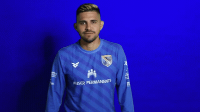 A Man Wearing A Blue Kaiser Permanente Jersey Looks Down GIF