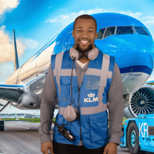 A Man Wearing A Blue Klm Vest Stands In Front Of A Blue Airplane GIF
