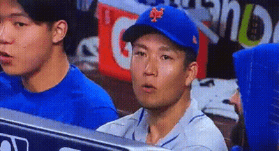 A Man Wearing A Blue Mets Hat Sits In A Dugout GIF