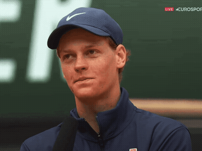 A Man Wearing A Blue Nike Hat Stands In Front Of A Sign That Says Eurosport GIF