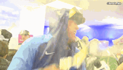 A Man Wearing A Blue Nike Hoodie Stands In Front Of A Camera GIF