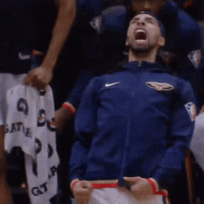 A Man Wearing A Blue Nike Jacket Is Screaming In The Stands GIF
