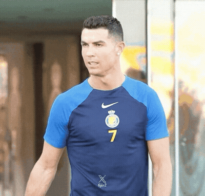 A Man Wearing A Blue Nike Shirt With The Number 7 On The Front GIF