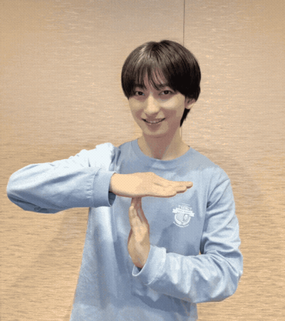 A Man Wearing A Blue Polo Shirt Is Making A Stop Sign GIF