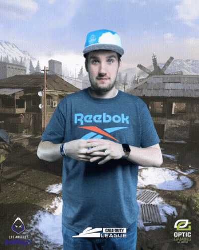 A Man Wearing A Blue Reebok Shirt Stands In Front Of A Call Of Duty Background GIF