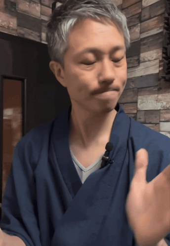 A Man Wearing A Blue Robe With A Microphone On It GIF