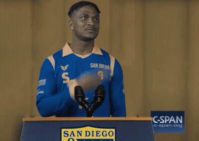A Man Wearing A Blue San Diego Jersey Stands Behind A Podium GIF