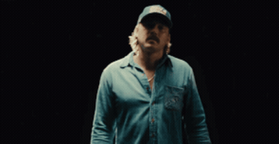 A Man Wearing A Blue Shirt And A Hat That Says Field & Stream GIF