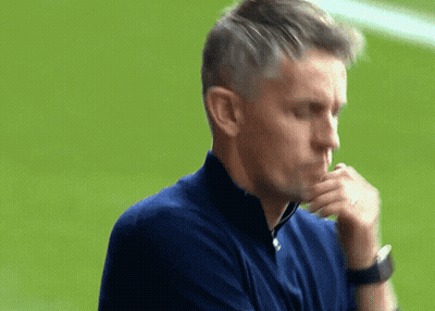 A Man Wearing A Blue Shirt And A Watch Looks Down At Something GIF