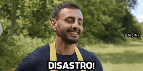 A Man Wearing A Blue Shirt And A Yellow Apron Is Smiling And Saying Disaster GIF