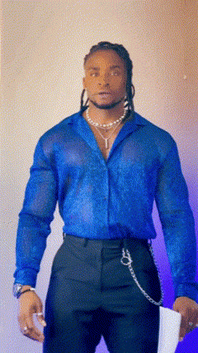A Man Wearing A Blue Shirt And Black Pants Holds A Piece Of Paper GIF