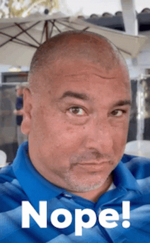 A Man Wearing A Blue Shirt Has The Word Nope Written On His Face GIF