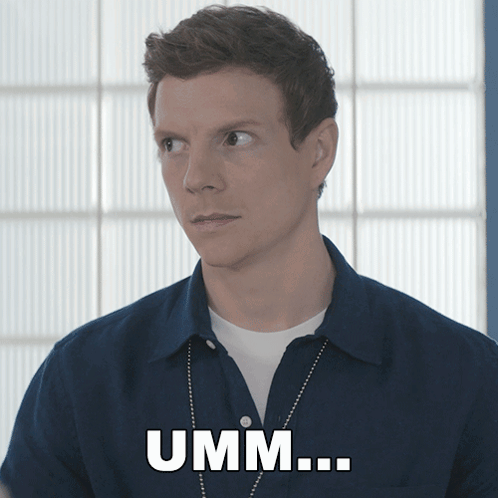 A Man Wearing A Blue Shirt Has The Word Umm On His Shirt GIF