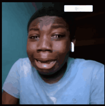 A Man Wearing A Blue Shirt Is Smiling And Making A Funny Face GIF