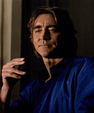 A Man Wearing A Blue Shirt Is Smoking A Cigarette GIF