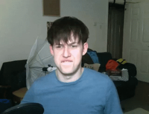 A Man Wearing A Blue Shirt Making A Funny Face GIF