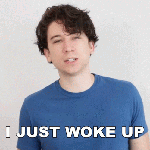 A Man Wearing A Blue Shirt Says I Just Woke Up GIF