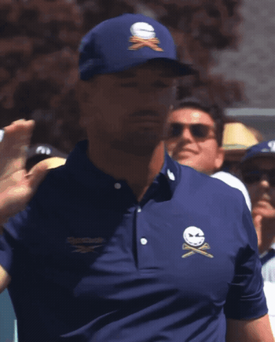 A Man Wearing A Blue Shirt That Has The Word Golf On The Sleeve GIF