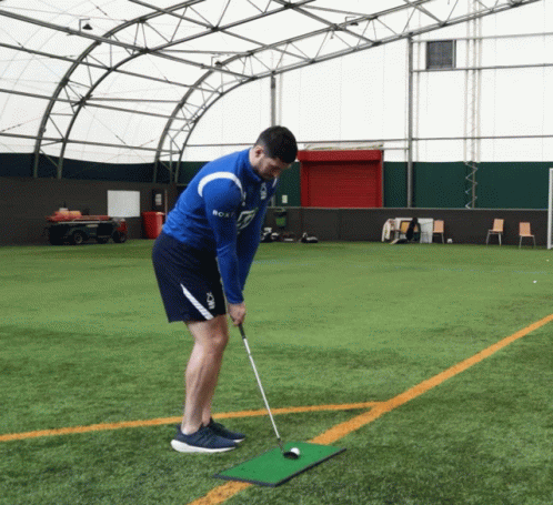 A Man Wearing A Blue Shirt That Says Bca On It Playing Golf GIF