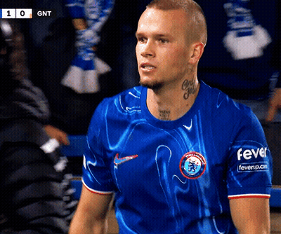 A Man Wearing A Blue Shirt That Says Fever On The Sleeves GIF