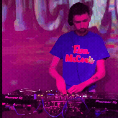 A Man Wearing A Blue Shirt That Says Flan Mccools Is Playing Music GIF