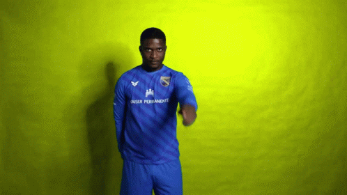 A Man Wearing A Blue Shirt That Says Laser Permanente On It GIF