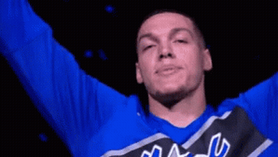A Man Wearing A Blue Shirt That Says Magic Is Smiling GIF