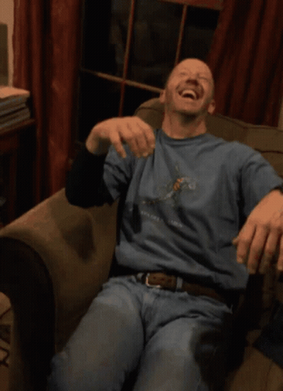 A Man Wearing A Blue Shirt That Says New York Is Laughing GIF