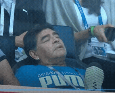 A Man Wearing A Blue Shirt That Says Puma Is Laying Down GIF