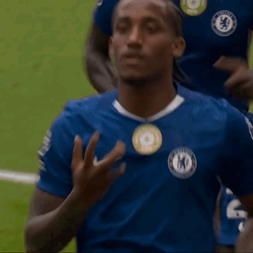 A Man Wearing A Blue Shirt With A Badge That Says Chelsea On It GIF