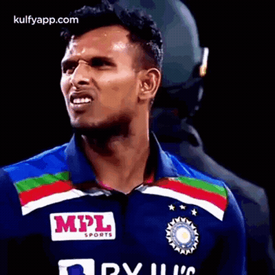 A Man Wearing A Blue Shirt With A Mpl Sports Logo On It . GIF