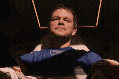 A Man Wearing A Blue Shirt With A Patch That Says " Half Moon " GIF