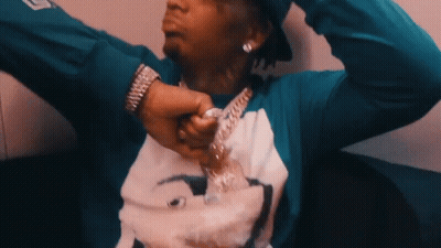 A Man Wearing A Blue Shirt With A Picture On It GIF