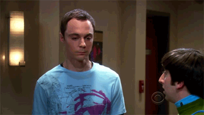 A Man Wearing A Blue Shirt With A Purple Design On It Is Talking To Another Man GIF