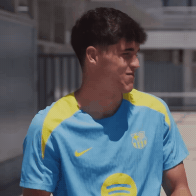 A Man Wearing A Blue Shirt With A Yellow Circle On It GIF