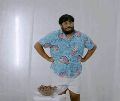 A Man Wearing A Blue Shirt With Pineapples On It GIF