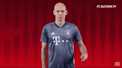 A Man Wearing A Blue Shirt With The Letter T. GIF
