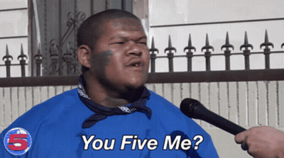 A Man Wearing A Blue Shirt With The Number 5 On It Is Talking Into A Microphone GIF