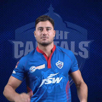 A Man Wearing A Blue Shirt With The Word Capitals On The Back GIF
