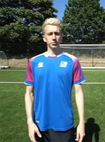 A Man Wearing A Blue Shirt With The Word Errea On The Front GIF