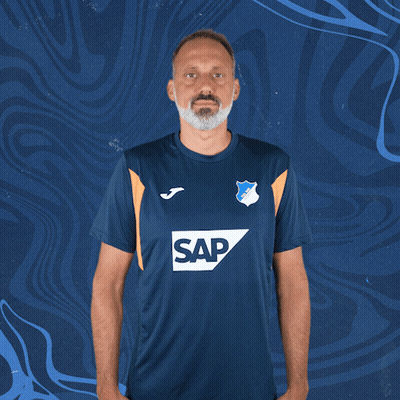 A Man Wearing A Blue Shirt With The Word Sap On The Front GIF