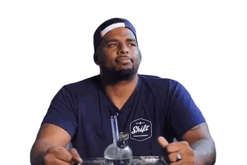 A Man Wearing A Blue Shirt With The Word Shift On The Front Sticker