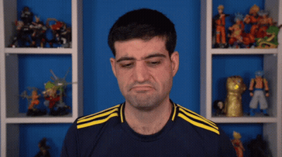 A Man Wearing A Blue Shirt With Yellow Stripes Is Making A Face GIF