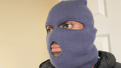 A Man Wearing A Blue Ski Mask With A Hole In The Middle Of His Face GIF