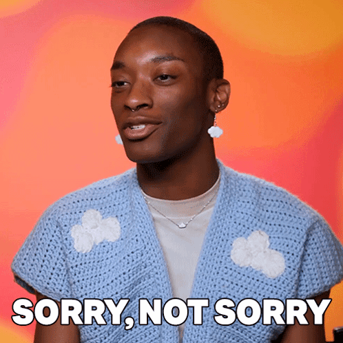 A Man Wearing A Blue Sweater And Earrings Says " Sorry Not Sorry " GIF