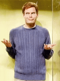 A Man Wearing A Blue Sweater Is Making A Funny Face GIF