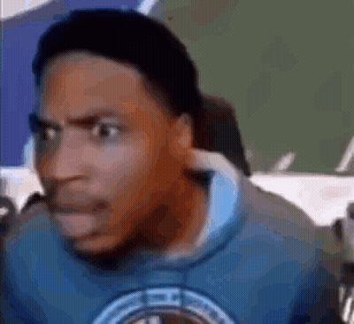 A Man Wearing A Blue Sweatshirt Is Making A Funny Face . GIF