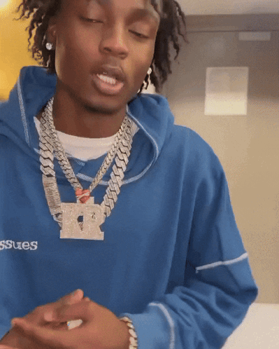 A Man Wearing A Blue Sweatshirt With The Word Issues On The Front GIF